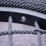 Close-up of the woven rope seat and black frame of the Single Swing (BNS 90cm) playground equipment.
