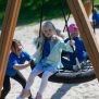 Single Swing (BNS 90cm) with children playing on the round net swing seat attached to wooden frame.