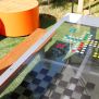 HPL Bench Chess and ludo game with wooden seating and colourful game pieces on a glass tabletop.