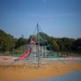 Powerclimber climbing net with blue ropes and metal frame on playground surface
