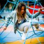 Child climbing on blue Powerclimber climbing net playground equipment