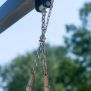 Close-up of chain suspension detail on Silver Single Swing playground equipment.